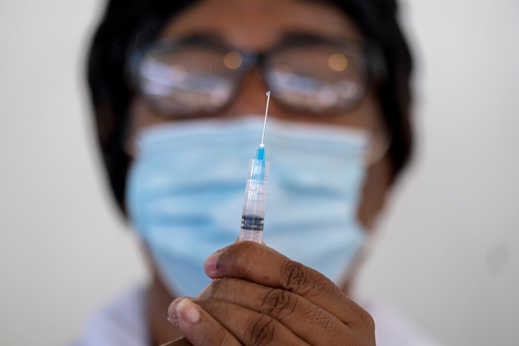 A health worker prepares a syringe with a dose of the Moderna COVID-19 vaccine at the Saint Damien Hospital in Port-au-Prince, Haiti July 19, 2021. REUTERS/Ricardo Arduengo - RC2NNO98UCLA