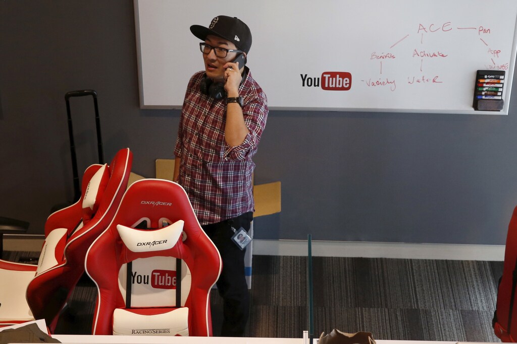 A man talks on the phone at the YouTube Space LA in Playa Del Rey, Los Angeles, California, United States October 21, 2015. Alphabet Inc's YouTube will launch a $10-a-month subscription option in the United States on October 28 that lets viewers watch videos from across the site without interruption from advertisements, the company said on Wednesday. REUTERS/Lucy Nicholson - RTS5IGA