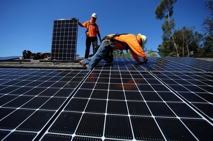 Solar installers from Baker Electric place solar panels on the roof of a residential home in Scripps Ranch, San Diego, California, U.S. October 14, 2016. Picture taken October 14, 2016. REUTERS/Mike Blake