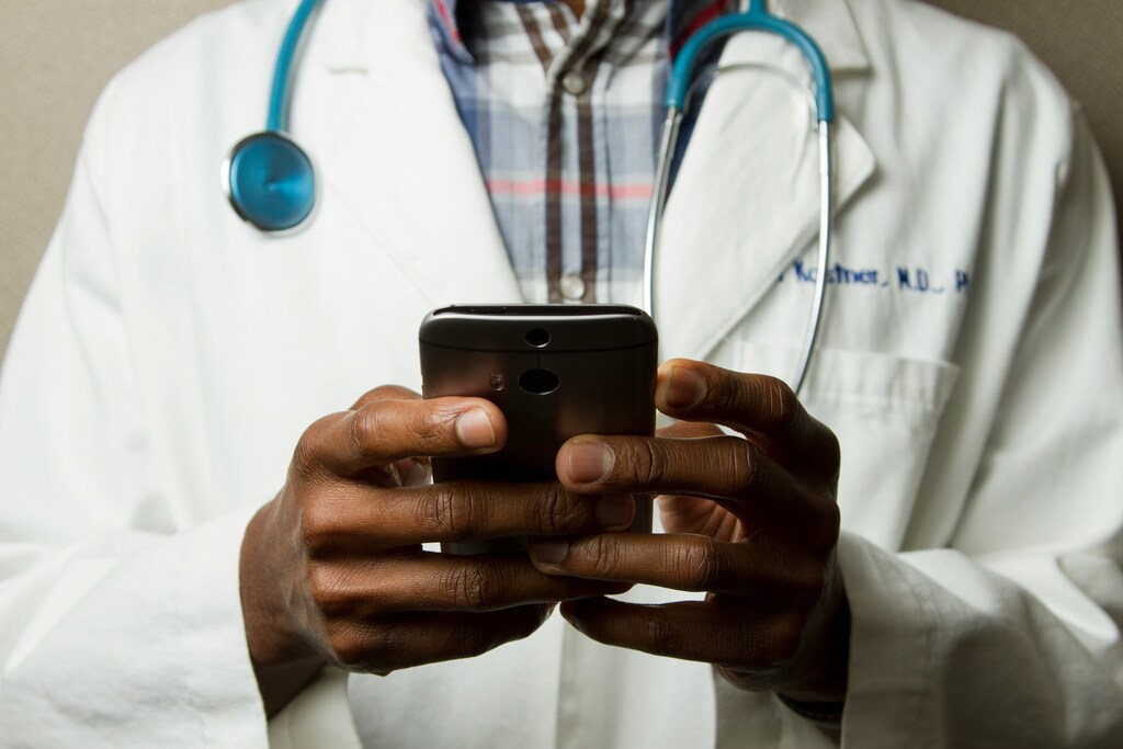 Doctor Holding Cell Phone. data