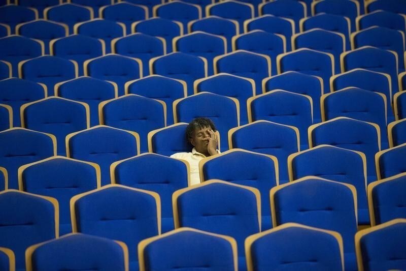 A man takes a nap during a rehearsal of the Minnesota Orchestra in Havana, May 15, 2015. The Minnesota Orchestra is in Cuba to perform at the National Theatre in Havana on May 15 and 16. REUTERS/Alexandre Meneghini TPX IMAGES OF THE DAY - GF10000096513