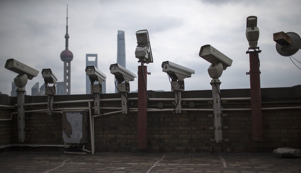 Security cameras are seen on a building at the Bund in front of the financial district of Pudong in Shanghai March 6, 2015.