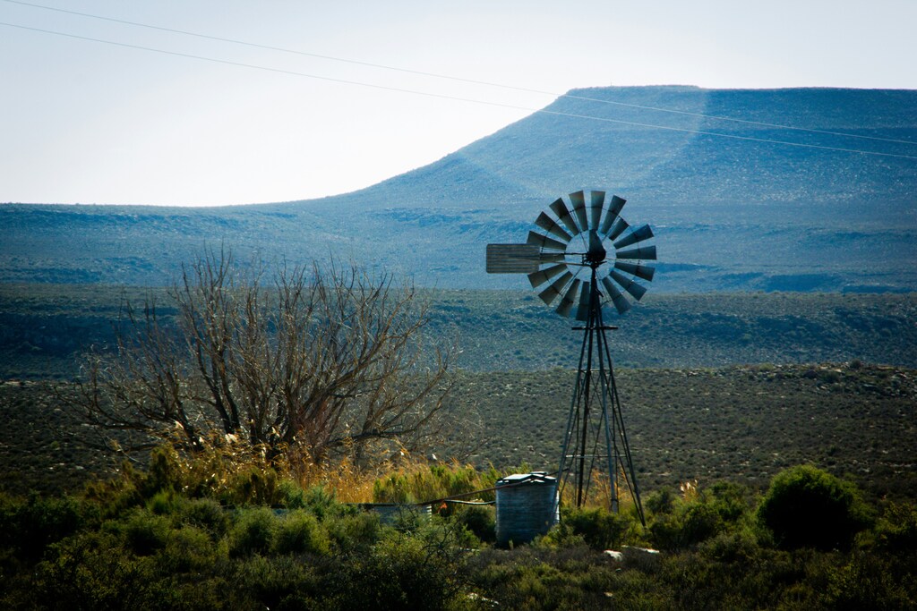 A wind turbine on a farm, illustrating the need for adaptation finance