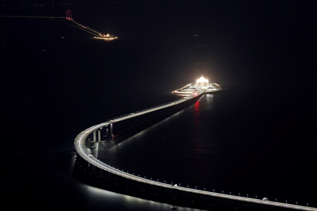 An evening view of the Hong Kong-Zhuhai-Macau bridge and its entrances to a cross sea tunnel, off Lantau island in Hong Kong, China October 21, 2018, before its opening ceremony on October 23, 2018. Picture taken October 21, 2018. REUTERS/Bobby Yip TPX IMAGES OF THE DAY - RC1D8AEFCA80