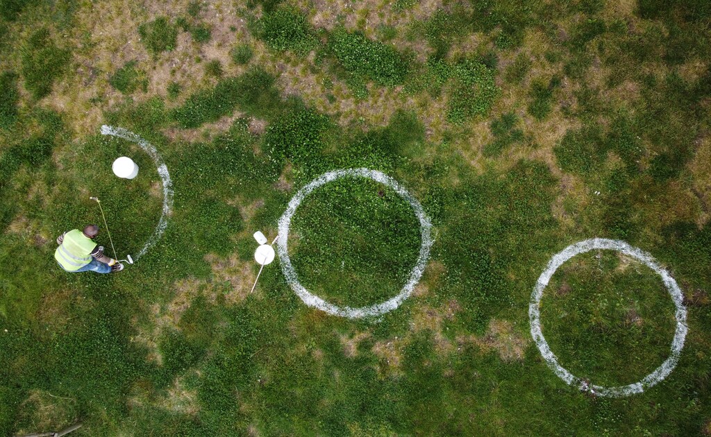 A municipality worker paints circles as guidelines for social distancing at Dalyan Park during a 4-day curfew amid the spread of the coronavirus disease (COVID-19), in Istanbul, Turkey May 25, 2020. Picture taken with a drone.