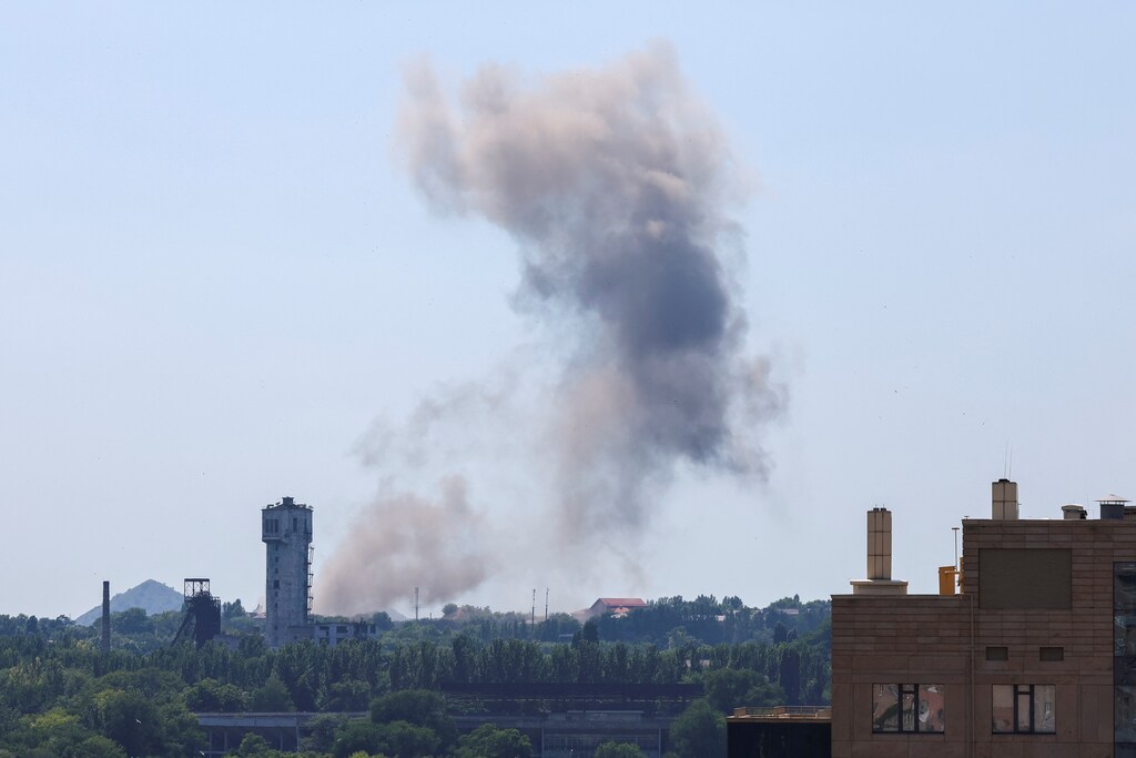 Smoke rises over the city following recent shelling in the course of Ukraine-Russia conflict in Donetsk, Ukraine June 20, 2022. Development Finance Initiatives (DFIs) can catalyze growth in fragile states.