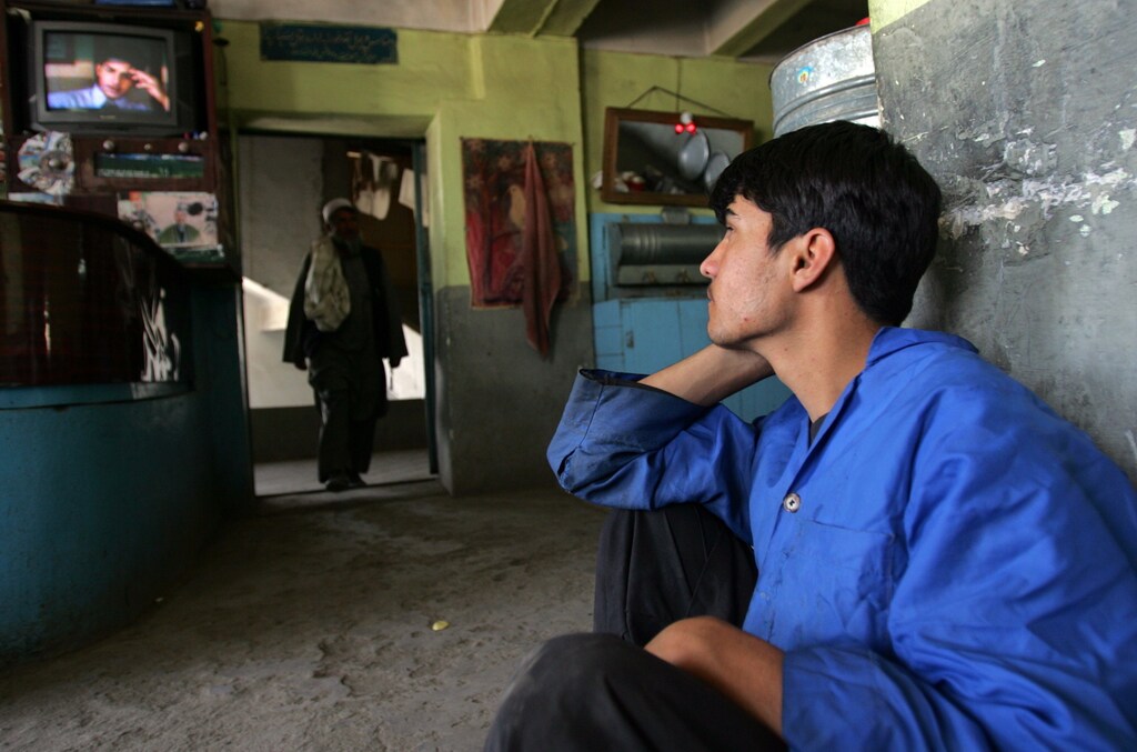 An Afghan waiter watches the Indian family series called 'Saas Bhi Kabhi Bahu Thi' at a resturant in Kabul, Afghanistan May 25, 2006.