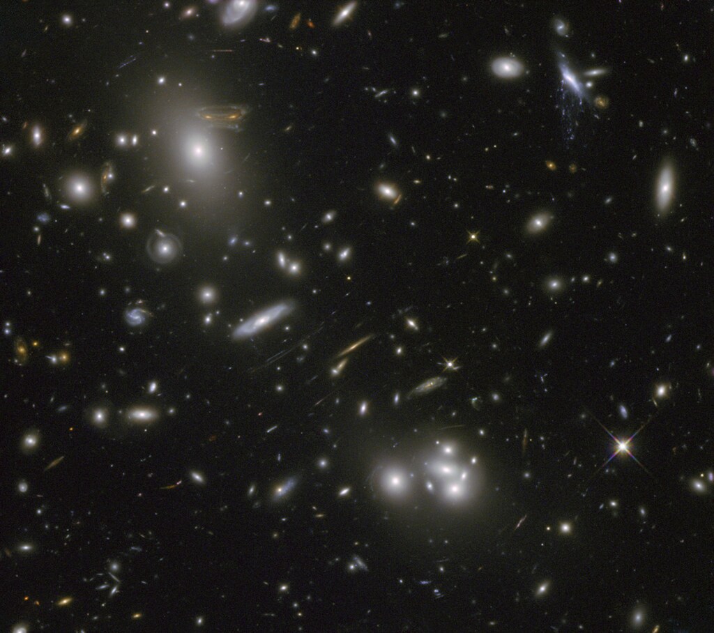 A massive cluster of galaxies, Abell 68, is pictured in this undated image courtesy of NASA and ESA. The image of a spiral galaxy at upper left has been stretched and mirrored into a shape similar to that of a simulated alien from the classic 1970s computer game "Space Invaders!". The gravitational field surrounding this cluster, acts as a natural lens in space to brighten and magnify the light coming from very distant background galaxies. Like a fun house mirror, lensing creates a fantasy landscape of arc-like images and mirror images of background galaxies. REUTERS/NASA/ESA/Handout (OUTER SPACE - Tags: SCIENCE TECHNOLOGY ENVIRONMENT) FOR EDITORIAL USE ONLY. NOT FOR SALE FOR MARKETING OR ADVERTISING CAMPAIGNS. THIS IMAGE HAS BEEN SUPPLIED BY A THIRD PARTY. IT IS DISTRIBUTED, EXACTLY AS RECEIVED BY REUTERS, AS A SERVICE TO CLIENTS - RTR3ELZJ