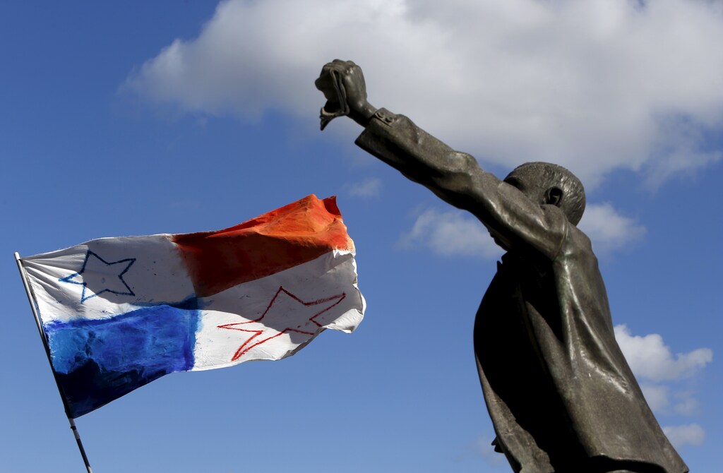 A Panamanian flag flies in the wind near a statue of Maltese pre-independence social reformer Manwel Dimech during a demonstration calling on Maltese Prime Minister Joseph Muscat to resign after two members of his government were named in the Panama Papers leak scandal, outside the office of the Prime Minister in Valletta, Malta, April 10, 2016. REUTERS/Darrin Zammit Lupi MALTA OUT. NO COMMERCIAL OR EDITORIAL SALES IN MALTA - RTX29C6I