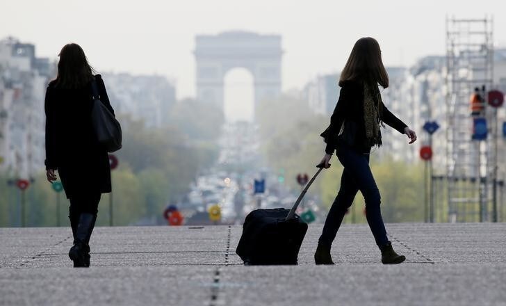 A businesswoman walks at La Defense business and financial district in Courbevoie near Paris, France on April 21, 2016. REUTERS/Gonzalo Fuentes