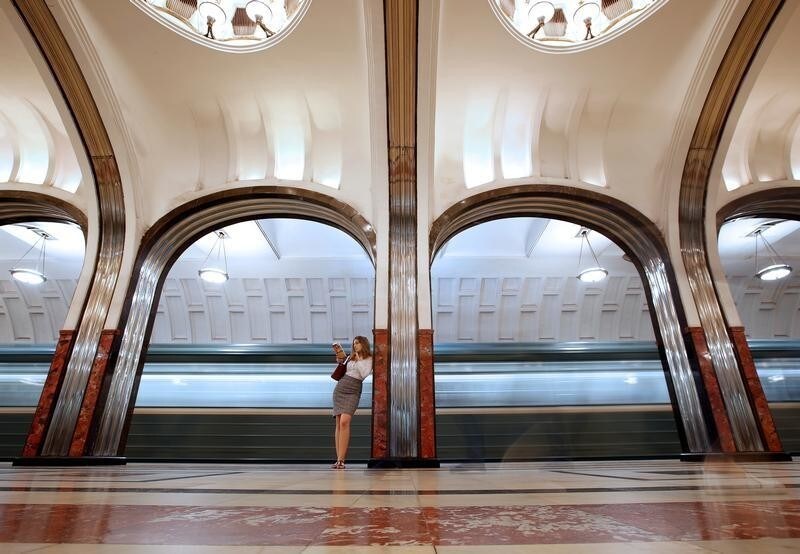 A woman reads a book at Mayakovskaya metro station in Moscow, Russia, June 22, 2018. As well as shooting all the matches, Reuters photographers are producing pictures showing their own quirky view from the sidelines of the World Cup.