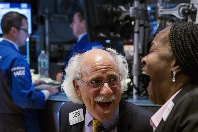 Traders laugh as they work on the floor of the New York Stock Exchange as the market closes in New York October 17, 2014. REUTERS/Lucas Jackson (UNITED STATES - Tags: BUSINESS TPX IMAGES OF THE DAY) - GM1EAAI0CGY01