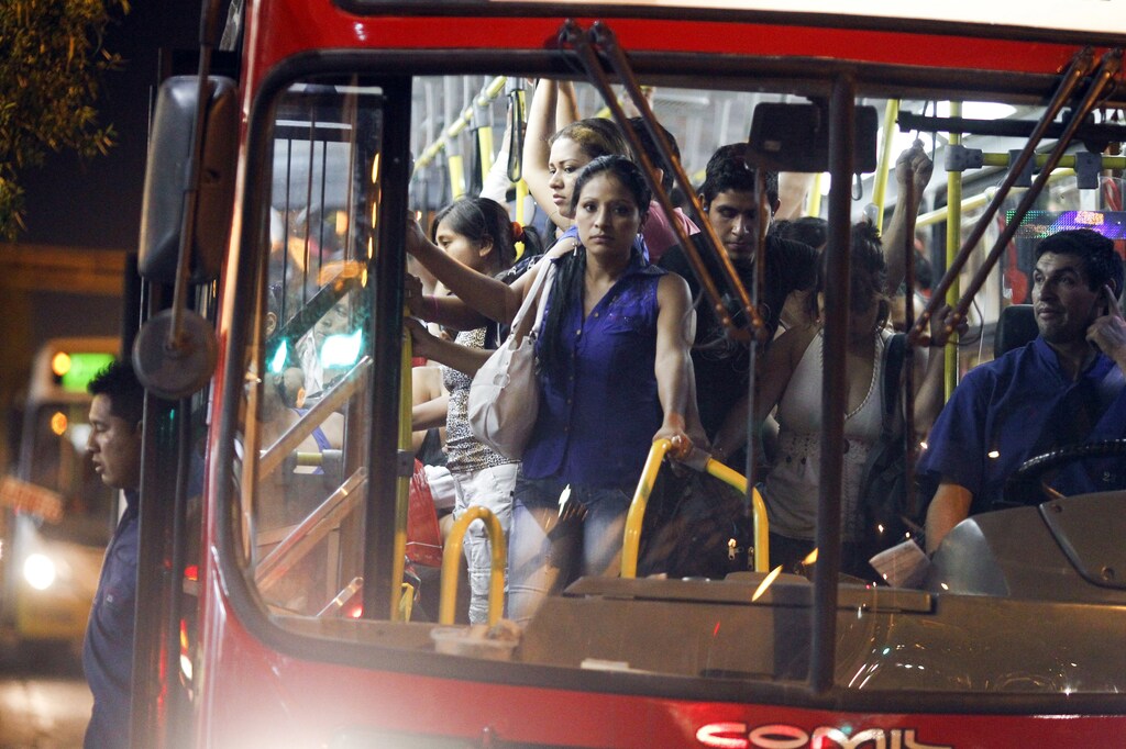 Passengers stand in a packed public bus in downtown Lima, March 15, 2014. Bogota and two other Latin American capitals - Mexico City, and Lima in Peru - were named as the three capitals with the least safe transport systems for women in the Thomson Reuters Foundation poll of more than 6,550 women and gender and city planning experts. Women in Latin America say they face a wide range of daily threats on public transport, and not enough is done to ensure their safety. Picture taken March 15, 2014. To match Thomson Reuters Foundation story WOMEN/POLL-LATAM REUTERS/Enrique Castro-Mendivil (PERU - Tags: SOCIETY TRANSPORT TPX IMAGES OF THE DAY) - RTR4BYTW