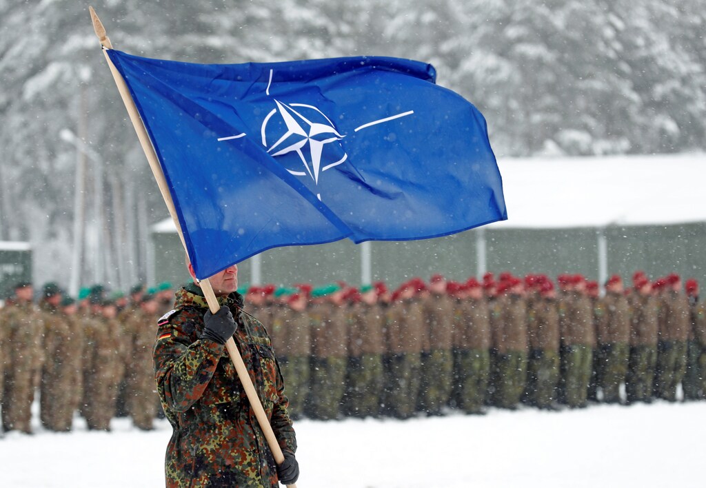 A soldier carries the NATO flag during German Minister of Defence Ursula von der Leyen's visit to German troops deployed as part of NATO enhanced Forward Presence (eFP) battle group in Rukla military base, Lithuania February 4, 2019. REUTERS/Ints Kalnins - RC1587B67C10
