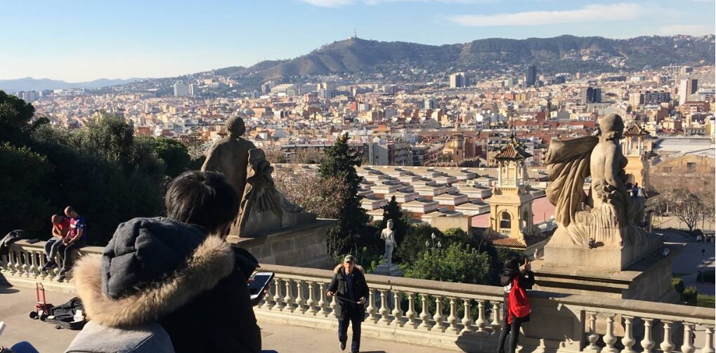 People look out over Barcelona from the city’s iconic hill, Montjuic, in Barcelona, Spain, February 4, 2019. Thomson Reuters Foundation/Sophie Davies.