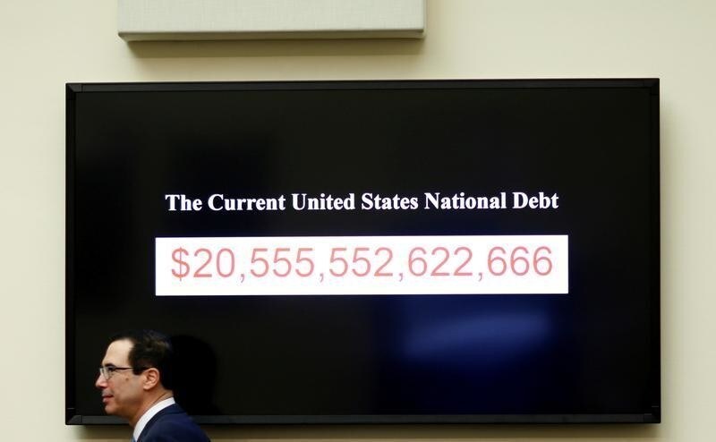 Treasury Secretary Steven Mnuchin walks past a display of the U.S. national debt as he testifies to the House Financial Services Committee on "The Annual Report of the Financial Stability Oversight Council", on Capitol Hill in Washington, U.S., February 6, 2018.