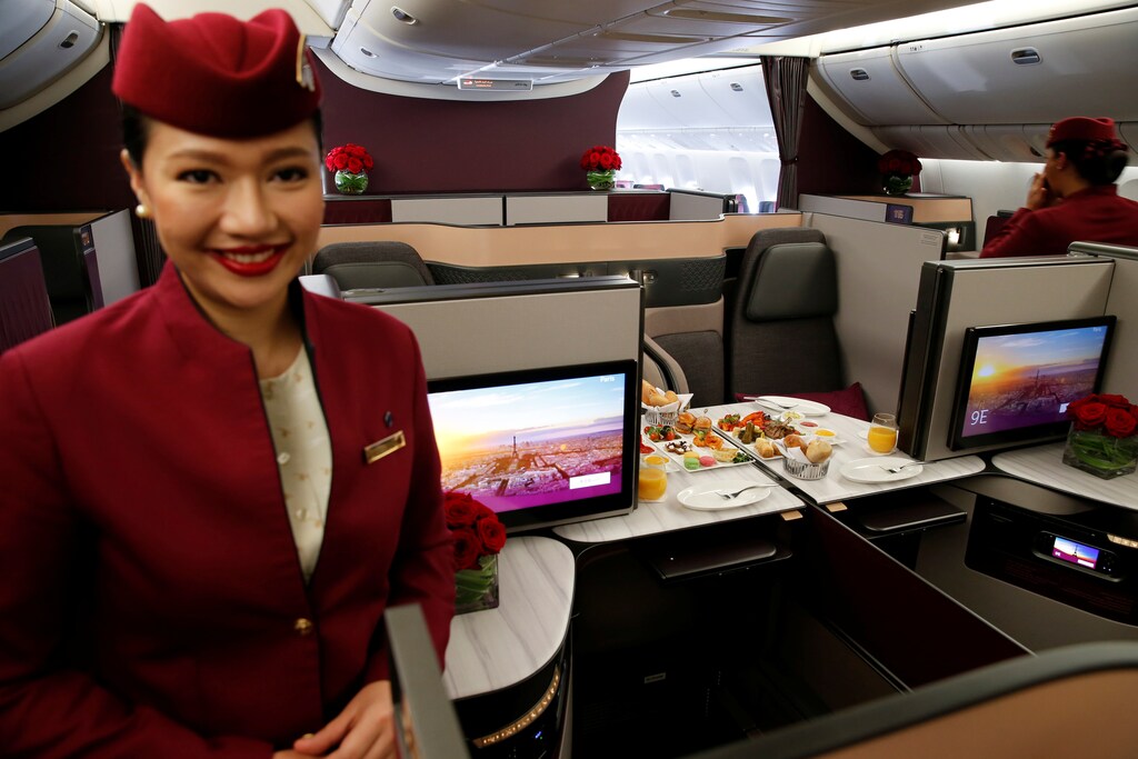 A Qatar Airways crew member presents the business class seats of an Boeing 777 aircraft during the 52nd Paris Air Show at Le Bourget airport near Paris, France, June 19, 2017. REUTERS/Pascal Rossignol - RTS17OSN