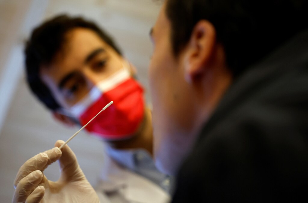 A medical worker administers a nasal swab to a patient at a coronavirus disease (COVID-19) testing centre in Nantes, near Nantes, France, June 30, 2022. REUTERS/Stephane Mahe