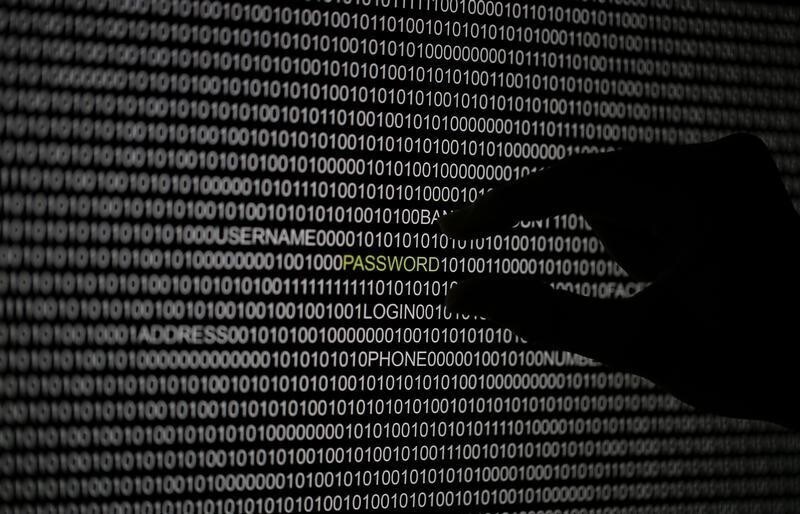 A hand is silhouetted in front of a computer screen in this picture illustration taken in Berlin May 21, 2013. The Financial Times' website and Twitter feeds were hacked May 17, 2013, renewing questions about whether the popular social media service has done enough to tighten security as cyber-attacks on the news media intensify. The attack is the latest in which hackers commandeered the Twitter account of a prominent news organization to push their agenda. Twitter's 200 million users worldwide send out more than 400 million tweets a day, making it a potent distributor of news. REUTERS/Pawel Kopczynski (GERMANY - Tags: CRIME LAW SCIENCE TECHNOLOGY) - RTXZUYD