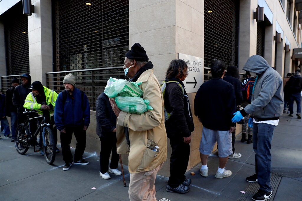 People wait in line to check-in for the night, amid an outbreak of the coronavirus disease (COVID-19), at the St. Anthonyâs winter shelter in San Francisco, California, U.S., March 25, 2020. Picture taken March 25, 2020. REUTERS/Shannon Stapleton TPX IMAGES OF THE DAY - RC2SWF99VA0Y