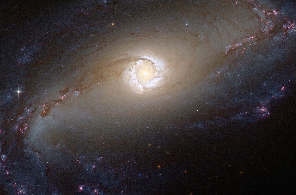 FILE PHOTO: This NASA/ESA Hubble Space Telescope image shows the bright star-forming ring that surrounds the heart of the barred spiral galaxy NGC 1097, a Seyfert galaxy. NASA/ESA/Hubble/Handout via REUTERS/File Photo - RTX39J0Z
