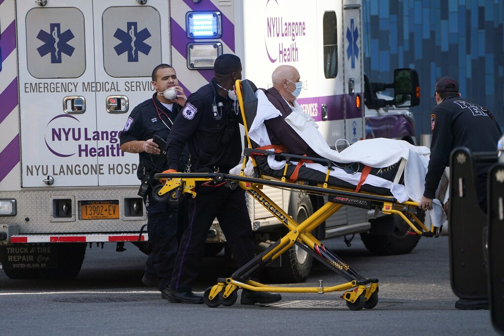 Paramedics wheel a patient into a hospital following the outbreak of coronavirus disease (COVID-19), in the Manhattan borough of New York City, New York, U.S., March 18, 2020. REUTERS/Carlo Allegri - RC2HMF98J62F