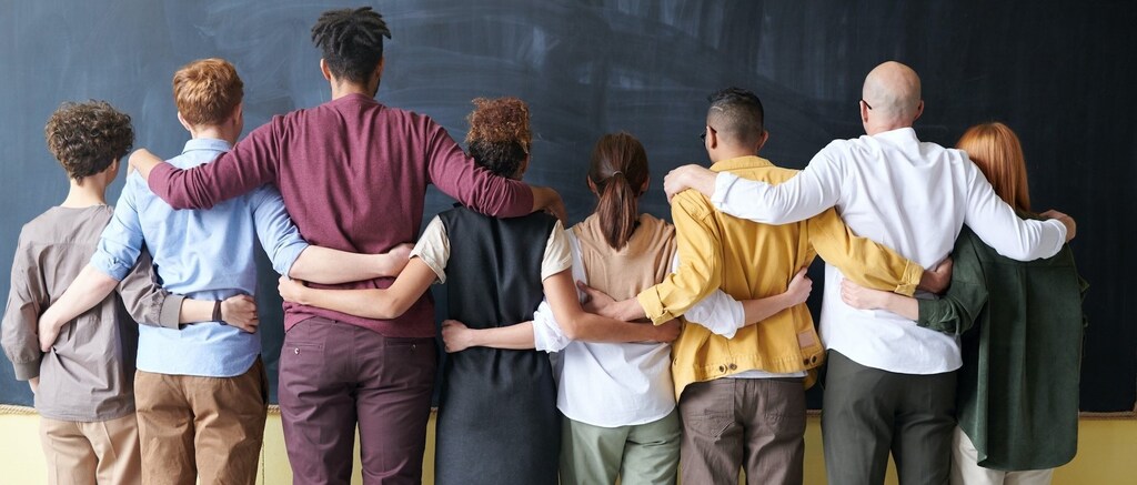 a diverse group of people facing away from the camera -- diversity backlash is underway