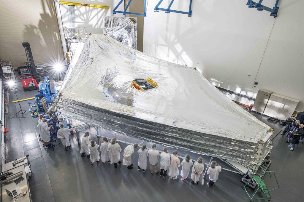 The Sunshield test unit to be used on NASA's James Webb Space Telescope is stacked and expanded at a cleanroom in the Northrop Grumman facility in Redondo Beach, California, in this NASA handout picture released July 25, 2014. The Sunshield separates the observatory into a warm sun-facing side and a cold side where the sunshine is blocked from interfering with the sensitive infrared instruments. REUTERS/NASA/Chris Gunn/Handout (UNITED STATES - Tags: SCIENCE TECHNOLOGY) ATTENTION EDITORS - THIS PICTURE WAS PROVIDED BY A THIRD PARTY. REUTERS IS UNABLE TO INDEPENDENTLY VERIFY THE AUTHENTICITY, CONTENT, LOCATION OR DATE OF THIS IMAGE. THIS PICTURE IS DISTRIBUTED EXACTLY AS RECEIVED BY REUTERS, AS A SERVICE TO CLIENTS. FOR EDITORIAL USE ONLY. NOT FOR SALE FOR MARKETING OR ADVERTISING CAMPAIGNS - TM3EA7P0U2M01