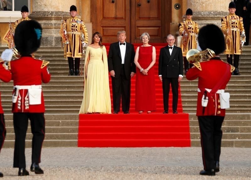British Prime Minister Theresa May and her husband Philip stand together with U.S. President Donald Trump and First Lady Melania Trump at the entrance to Blenheim Palace, where they are attending a dinner with specially invited guests and business leaders, near Oxford, Britain, July 12, 2018. REUTERS/Kevin Lamarque - RC1F856A4250