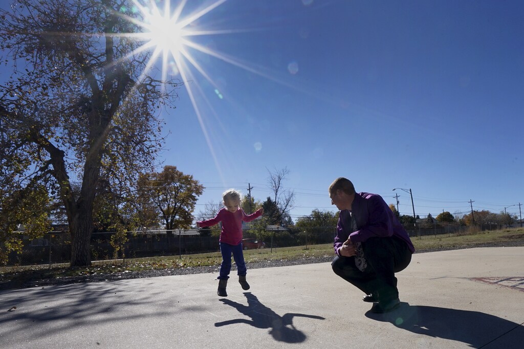 Peer 1 client Robert A. plays hopscotch with his 5-year-old daughter Isabella during Kid's Day at Peer 1 in Denver November 7, 2015. Peer 1 is a drug and alcohol rehabilitation programme for men, many having spent years in and out of prison, in Denver, Colorado. The men have often tried and failed over and over to turn their life around. With histories of abuse as children and living on the streets, they come to Peer 1 hoping to turn away from addiction and crime, to rebuild their lives and learn how to integrate into society. Treatment includes family group therapy, meditation and trust-building exercises. REUTERS/Rick WilkingPICTURE 25 OF 26 FOR WIDER IMAGE STORY "PEER 1: PRISON, DEATH OR RECOVERY". SEARCH "PEER WILKING" FOR ALL IMAGES - RTX1XP50