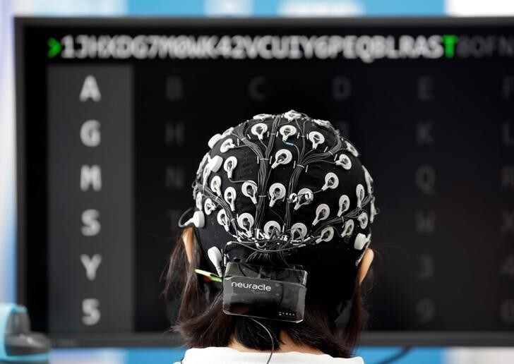 A participant competes during a Brain-Computer Interface (BCI) controlled robot contest at the World Robot Conference (WRC) in Beijing, China August 17, 2018. REUTERS/Jason Lee