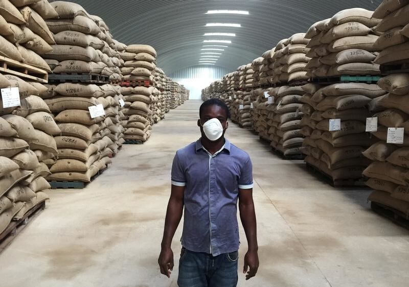 A worker stands near sacks of cocoa at the warehouses of SAF-Cacao in San Pedro, Ivory Coast October 12, 2016. Picture taken October 12, 2016. REUTERS/Ange Aboa - RC1F44557EE0