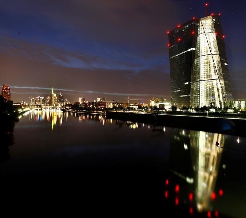 The skyline, with its characteristic banking towers and the headquarters of the European Central Bank (ECB, R), are reflected in river Main in Frankfurt, Germany, ctober 1, 2017. REUTERS/Kai Pfaffenbach - RC1F0B1CF000