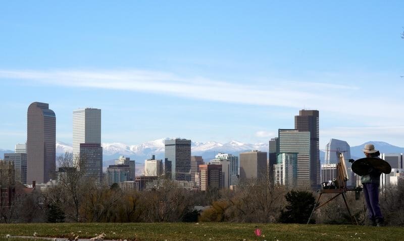 Dawn Cohen works on an oil painting of downtown Denver, in City Park in Denver, Colorado, U.S., November 16, 2017.