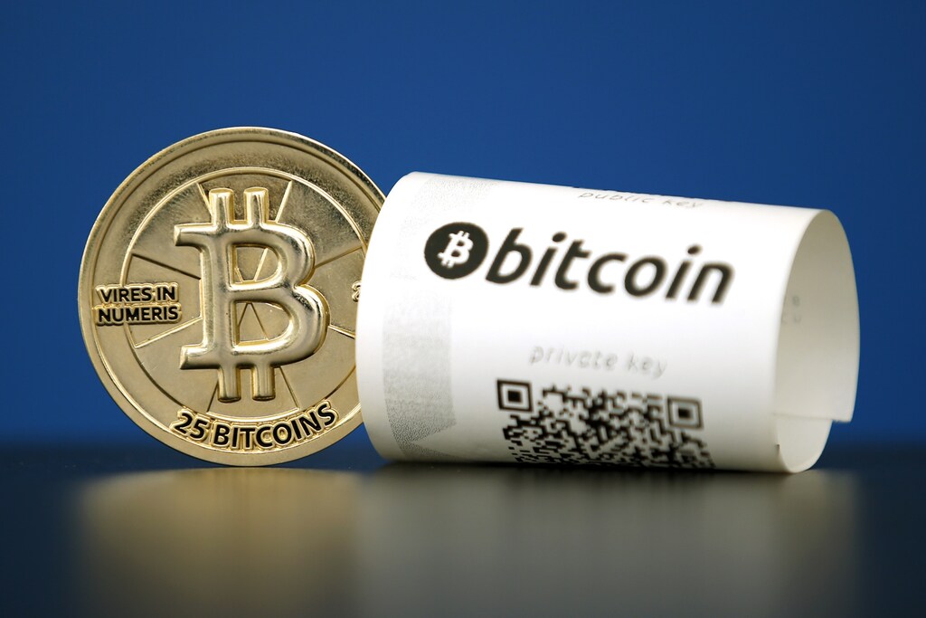 A Bitcoin (virtual currency) paper wallet with QR codes and a coin are seen in an illustration picture taken at La Maison du Bitcoin in Paris, France, May 27, 2015. British authorities have come out in support of digital currencies in the name of promoting financial innovation, while proposing that regulations should be drawn up to prevent their use in crime. But it is technophiles who are leading the drive to make London a real-world hub for trade in web-based "cryptocurrencies", of which bitcoin is the original and still most popular. Picture taken May 27, 2015. REUTERS/Benoit Tessier - RTX1EWTP
