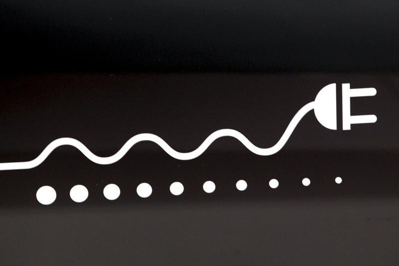 A plug logo is pictured on an Mitsubishi i-Miev electric car during the second media day of the 81st Geneva Motor Show at the Palexpo in Geneva March 2, 2011.