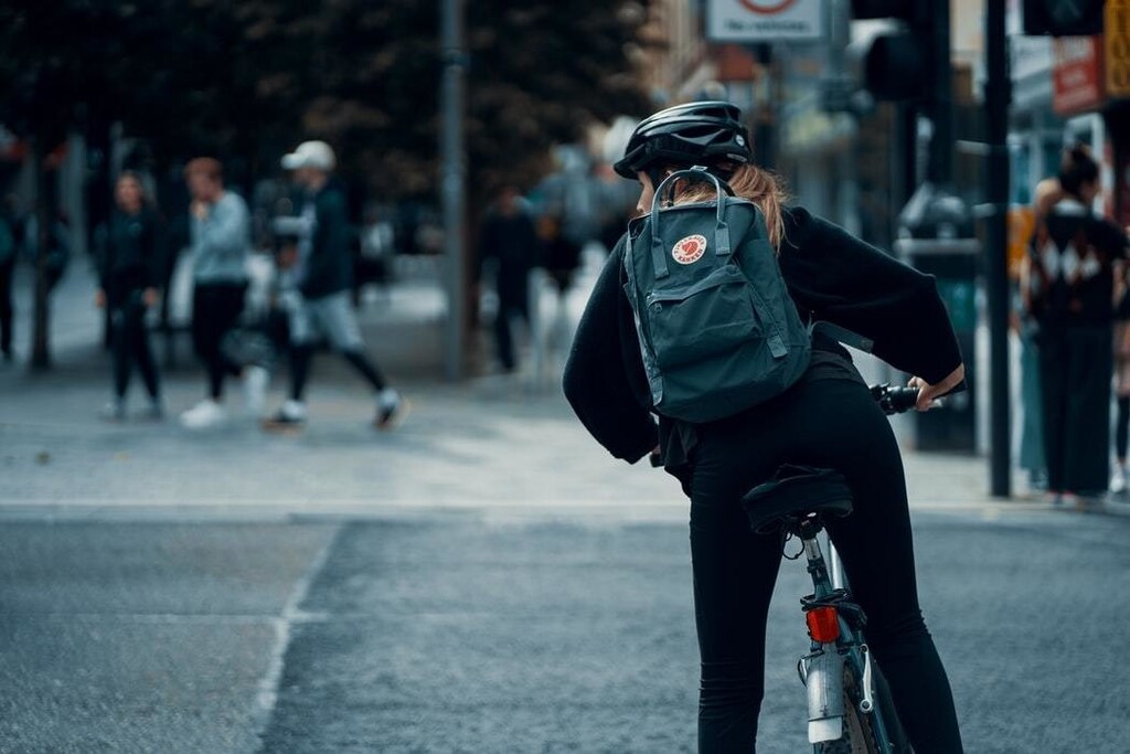 Women cycling in city, a form of exercise increasing during the COVID-19 pandemic.