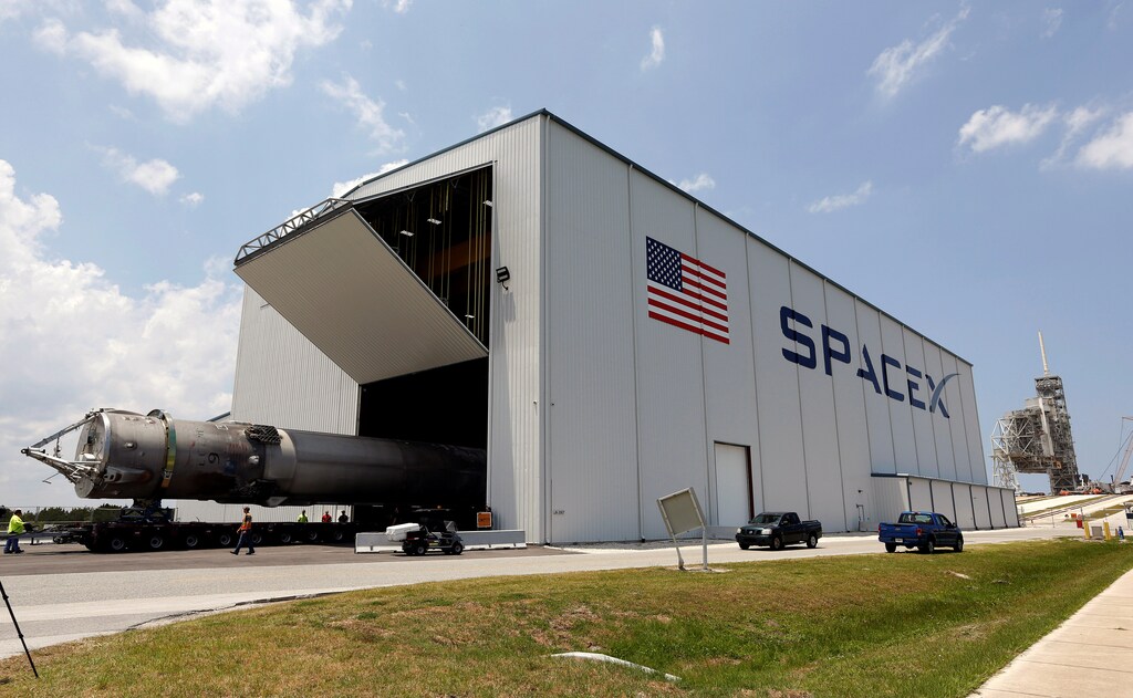 The recovered first stage of a SpaceX Falcon 9 rocket is transported to the SpaceX hangar at launch pad 39A at the Kennedy Space Center in Cape Canaveral, Florida May 14, 2016. The vehicle was launched on May 6 and returned to land a short time later aboard a barge in the Atlantic Ocean. REUTERS/Joe Skipper - RTSEB85