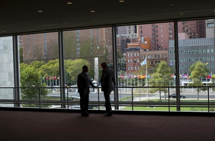Two diplomats talk in front of a window between the Secretariat and Assembly Buildings at the United Nations headquarters in New York City, September 21, 2015. As leaders from almost 200 nations gather for the annual general assembly at the United Nations, the world body created 70 years ago, Reuters photographer Mike Segar documented quieter moments at the famed 18-acre headquarters on Manhattan's East Side. The U.N., established as the successor to the failed League of Nations after World War Two to prevent a similar conflict from occurring again, attracts more than a million visitors every year to its iconic New York site. The marathon of speeches and meetings this year will address issues from the migrant crisis in Europe to climate change and the fight against terrorism. REUTERS/Mike SegarPICTURE 10 OF 30 FOR WIDER IMAGE STORY "INSIDE THE UNITED NATIONS HEADQUARTERS"SEARCH "INSIDE UN" FOR ALL IMAGES