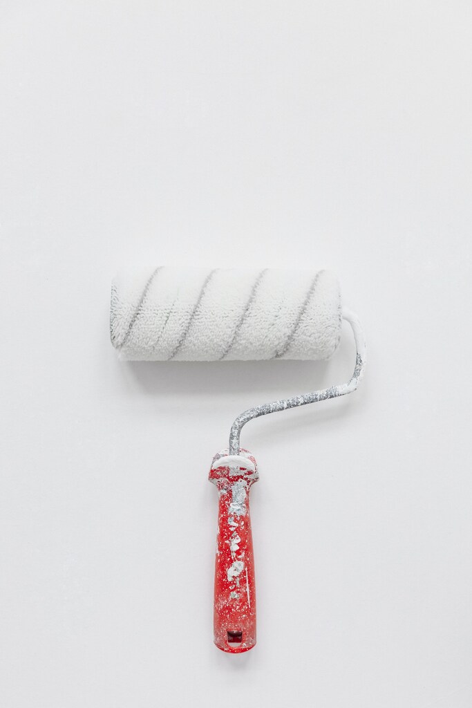 a picture of a paint roller with white paint on