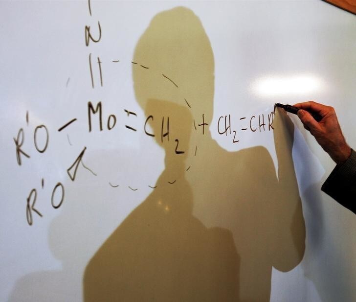 Massachusetts Institute of Technology professor and 2005 Nobel Prize in Chemistry winner Richard Schrock illustrates a double carbon bond at the Massachusetts Institute of Technology in Cambridge, Massachusetts October 5, 2005 after learning that he is being recognized with the Nobel Prize for his contribution to the development of the metathesis method in organic synthesis. Schrock will share the Nobel Prize with Yves Chauvin of the Institut Fran?ais du P?trole in France and Robert Grubbs of the California Institute of Technology (Caltech). Pictures of the Month October 2005 REUTERS/Brian Snyder