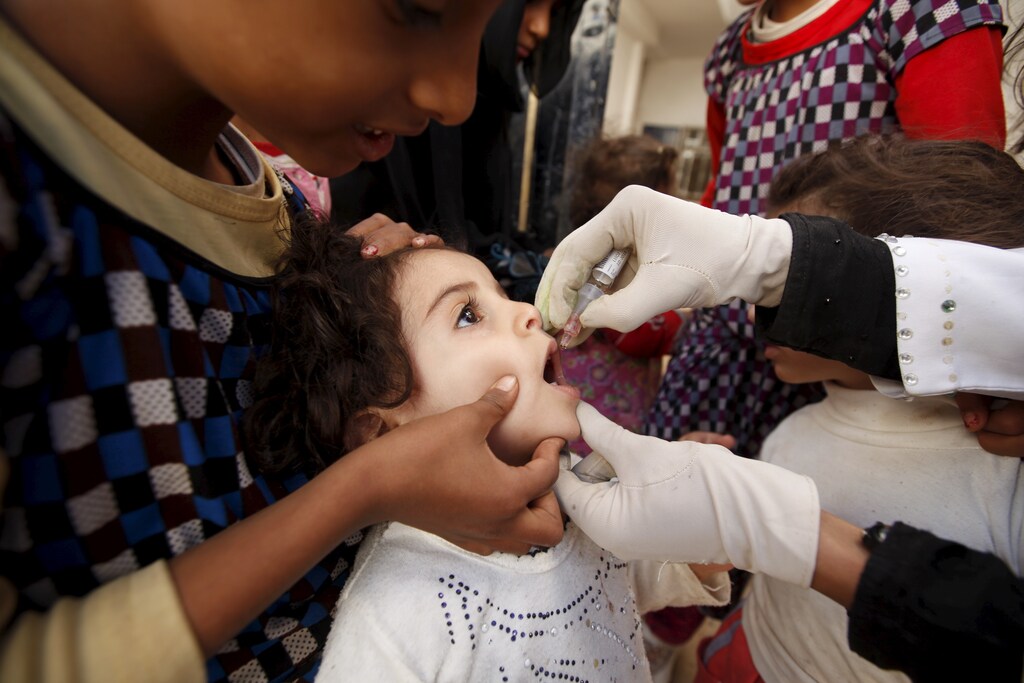 A girl receives polio vaccination outside her house in Yemen's capital Sanaa November 9, 2015.