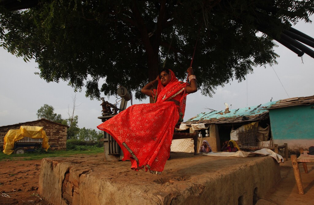 Child bride Krishna, 12, plays on an improvised swing outside her house in a village near Baran, located in the northwestern state of Rajasthan, July 30 , 2011. The legal age for marriage in India is 18, but marriages like these are common, especially in poor, rural areas where girls in particular are married off young. Some 47 percent of women aged between 20 and 24 years old were married before the age of 18, according to the government's latest National Family Health Survey. To match feature CHILDMARRIAGE/ REUTERS/Danish Siddiqui (INDIA - Tags: SOCIETY POLITICS) - RTR2PLPK