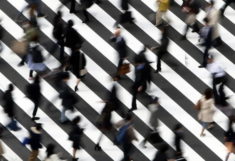 People cross a street in Tokyo March 18, 2015. Japanese blue-chip firms announced wage hikes on Wednesday that topped increases last year, but overall pay raises across corporate Japan are not expected to offset higher costs of living for workers or be enough to drive a sustainable economic recovery. REUTERS/Yuya Shino (JAPAN - Tags: BUSINESS EMPLOYMENT) - GM1EB3I18E901