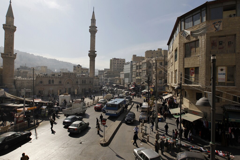 A general view of the downtown area of the Jordanian capital near the Grand Husseini mosque in Amman January 21, 2014. Brisk trading has returned to the bustling area, the scene of weekly anti-government protests inspired by the wave of Arab revolts that have now subsided. REUTERS/Muhammmad Hamed (JORDAN - Tags: CITYSCAPE BUSINESS SOCIETY RELIGION) - GM1EA1M00A201