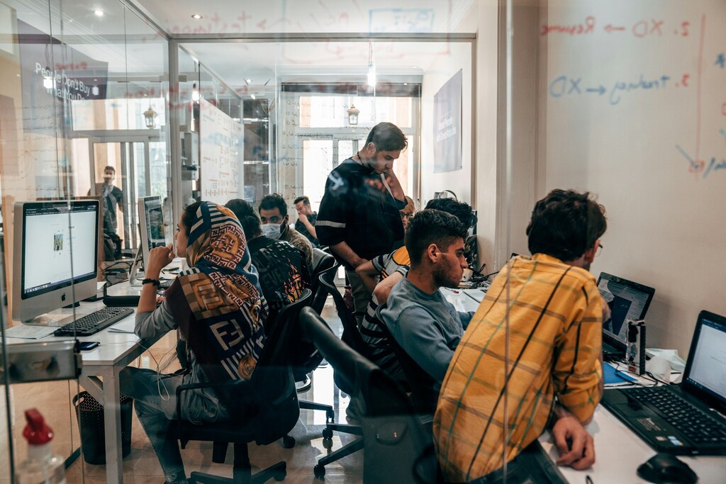 Men and women in an office. Investing in people and skills will be important in the AI age