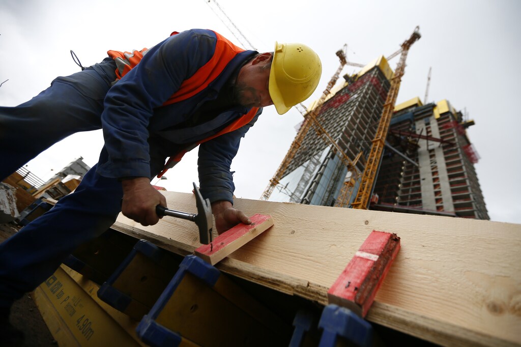 A construction worker prepares planks at the construction site of the new headquarters of the European Central Bank (ECB) in Frankfurt, April 26, 2012. The European Central Bank plans to move its headquarters in early 2014. REUTERS/Kai Pfaffenbach (GERMANY - Tags: BUSINESS POLITICS) - RTR318R3