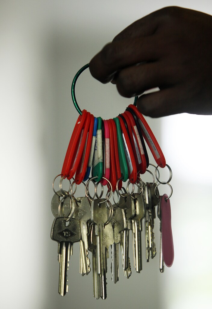 A worker shows a bunch of keys to newly completed apartments where he will be mending minor defects at a condominium project in Singapore October 24, 2013. From China to Canada and London, fast-rising property markets are haunting the global economy again, five years after the U.S. subprime mortgage bubble burst and triggered the worst financial crisis since the 1930s. Picture taken October 24, 2013. To match Insight ECONOMY-GLOBAL/PROPERTY REUTERS/Edgar Su (SINGAPORE - Tags: BUSINESS REAL ESTATE) - GM1E9AV1IBS01