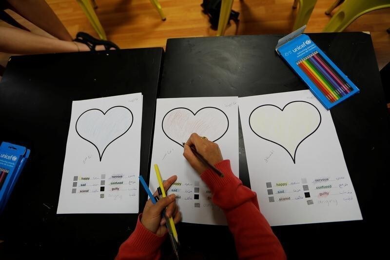Khalissa, 36, from Qamishli in Syria attends the open talk at the refugees and migrants Children and Family Protection Support Hub run by UNICEF partner Faros, in Athens, Greece, June 13, 2017. Khalissa was asked to fill a heart with colors to describe her past, present and future. Each color has its own meaning. Khalissa chose blue, brown and yellow, meaning sad, scared and happy. "Coming to the Faros centre takes people's minds off their own problems. It helps me to realise that I am not the only one to face dramatic situations... a lot of people like me have left a country that they cherish behind them," Khalissa said. "My husband has been in Germany for two years. A few days ago I had a positive response for my family reunification request, but I have no idea when I can finally leave Greece... waiting is terrible and so exhausting, I want some rest," she said. "My country was very safe and now it is completely destroyed...but if Syria becomes as before the war, I will return home. We must return home." REUTERS/Zohra Bensemra - RC1D6E02FCA0