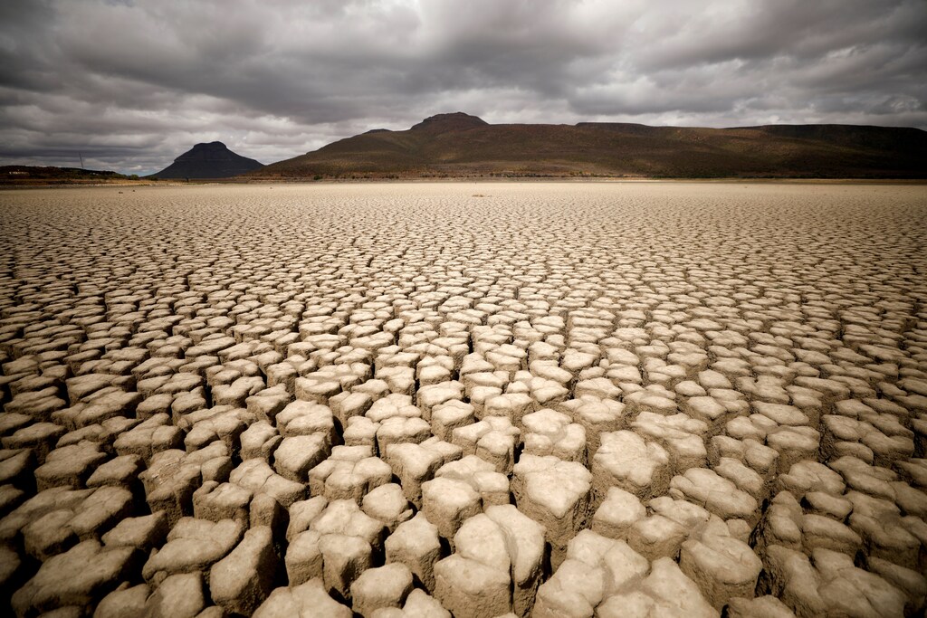 Clouds gather but produce no rain as cracks are seen in the dried up municipal dam in drought-stricken Graaff-Reinet, South Africa.